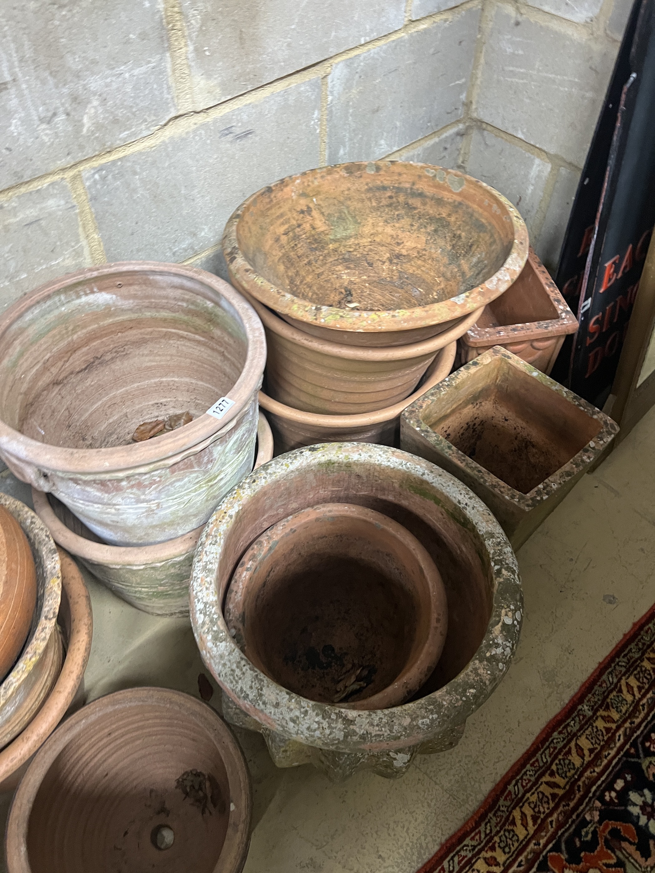 Fourteen assorted terracotta garden planters, largest diameter 42cm, height 40cm